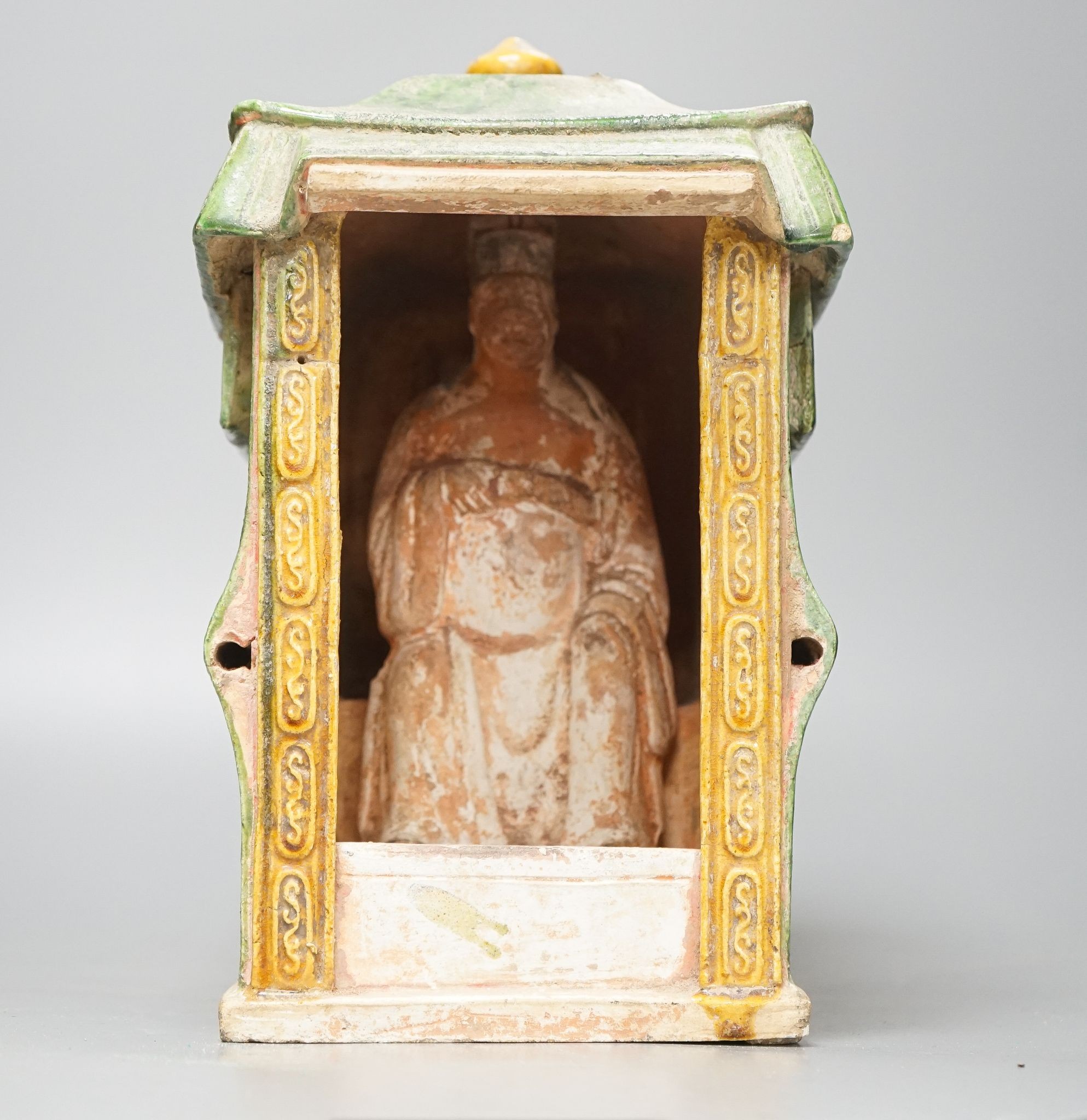 A Chinese Ming sancai-glazed model of a sedan chair with the figure Wenmu seated inside, 29cm